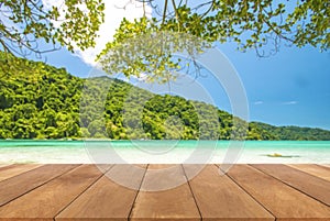 Wood table top and blue sky with seascape background