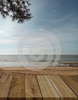 Wood table top on blur beach and sea background.