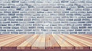 Wood table top on blur brick background.