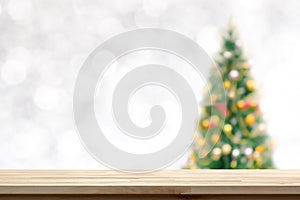 Wood table top on blur Christmas tree background