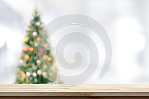 Wood table top on blur Christmas tree background