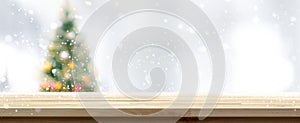 Wood table top on blur Christmas tree banner background