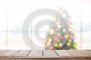 Wood table top with blur christmas tree bokeh background