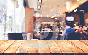 Wood table top with blur coffee shop,cafe background.