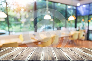 Wood table top with blur in coffee shop or cafe,restaurant background
