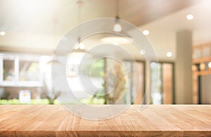 Wood table top with blur coffee shop or cafe,restaurant photo