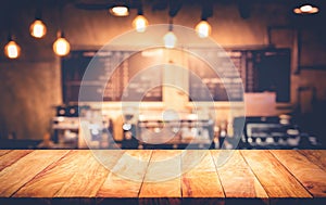 Wood table top with blur counter coffee shop, cafe background.