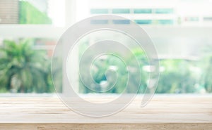 Wood table top on blur glass window background