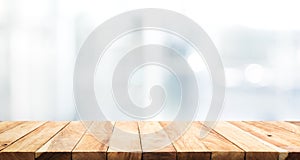 Wood table top on blur glass window wall building background