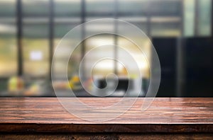 Wood table top on blur kitchen or cafe room background .For mont