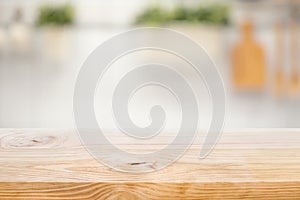 Wood table top on blur kitchen counter roombackground