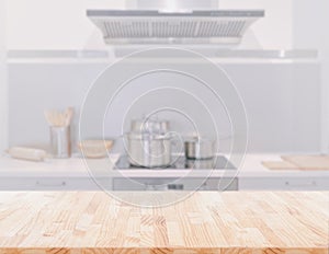 Wood table top on blur kitchen room background. can be used for display or montage your products