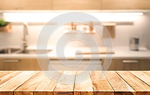 Wood table top on blur kitchen room background cooking concept