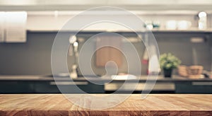 Wood table top on blur kitchen room background