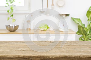 Wood table top on blur kitchen room counter background