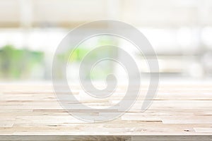 Wood table top on blur kitchen window background