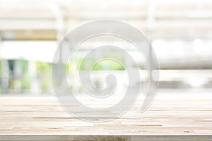 Wood table top on blur kitchen window background