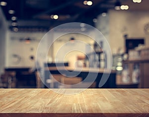 Wood table top with blur of people in coffee shop