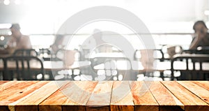 Wood table top with blur of people in coffee shop