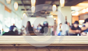 Wood table top with blur of people in coffee shop