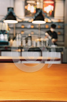 Wood table top with blur of people in coffee shop or cafe,restaurant  background photo