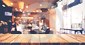 Wood table top with blur of people in coffee shop or cafe,restaurant photo