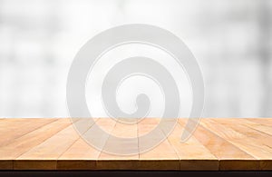 Wood table top on blur white abstract background.