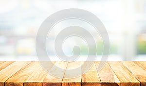 Wood table top on blur white glass wall background