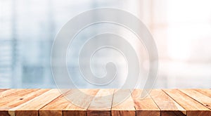 Wood table top on blur white glass window background form office
