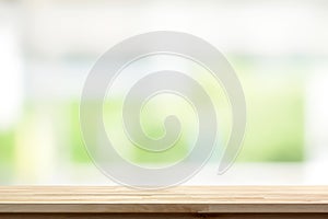 Wood table top on blur white green kitchen window background