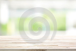 Wood table top on blur white green kitchen window background