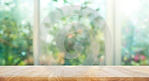 Wood table top on blur of window with garden flower background