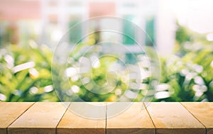 Wood table top on blur of window with garden flower background