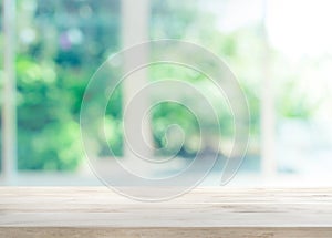 Wood table top on blur of window with garden flower background