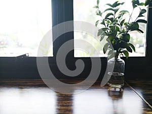 Wood table top on blur of window glass and abstract green from garden view in the morning background. For montage product display