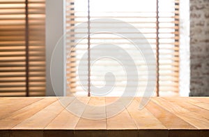 Wood table top with blur window shutters curtain background