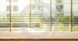 Wood table top with blur window shutters curtain background