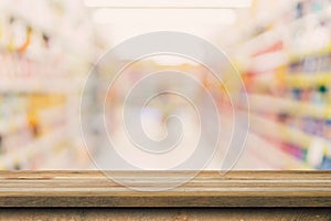 Wood table top on blurred background from shopping mall, Space for montage your product