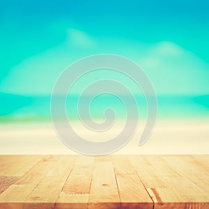 Wood table top on blurred beach background, vintage tone