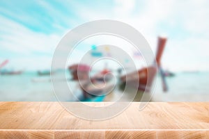 Wood table top on blurred blue sea and boat on beach background