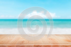 Wood table top on blurred blue sea and white sand beach background - can be used for display or montage your products