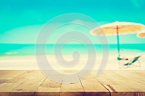 Wood table top on blurred blue sea and white sand beach background