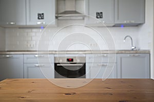 Wood table top on blurred kitchen background, scandinavian style