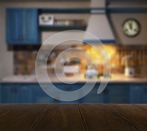 Wood table top and blurred kitchen interior background with vintage filter - can used for display or montage your products.