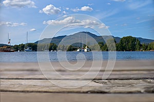 Wood table top with blurred nature scene tropical beach and blue sky, holiday background concept - can be used for