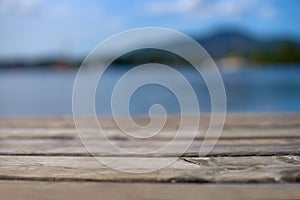 Wood table top with blurred nature scene tropical beach and blue sky, holiday background concept - can be used for