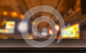 Wood table top and blurred of restaurant.