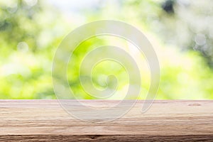 Wood table top on bokeh green bright background. For montage pro