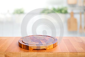 Wood table top with chopping board with blur kitchen counter background