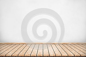 Wood table top with concrete wall background. Used for product placement or montage.